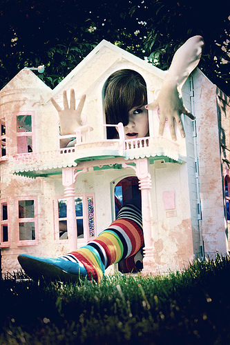 Alice in Wonderland based photo: arms and legs sticking out of a small house.
