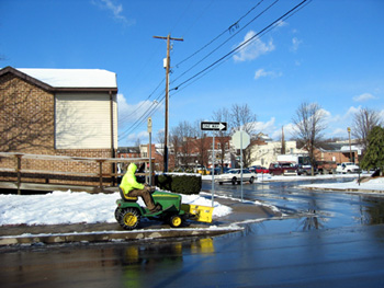 Man riding snow plow (click to enlarge)