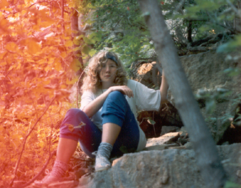 Alyce as a college undergrad, on some rocks
