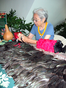 Making a feather lei (Click to enlarge)
